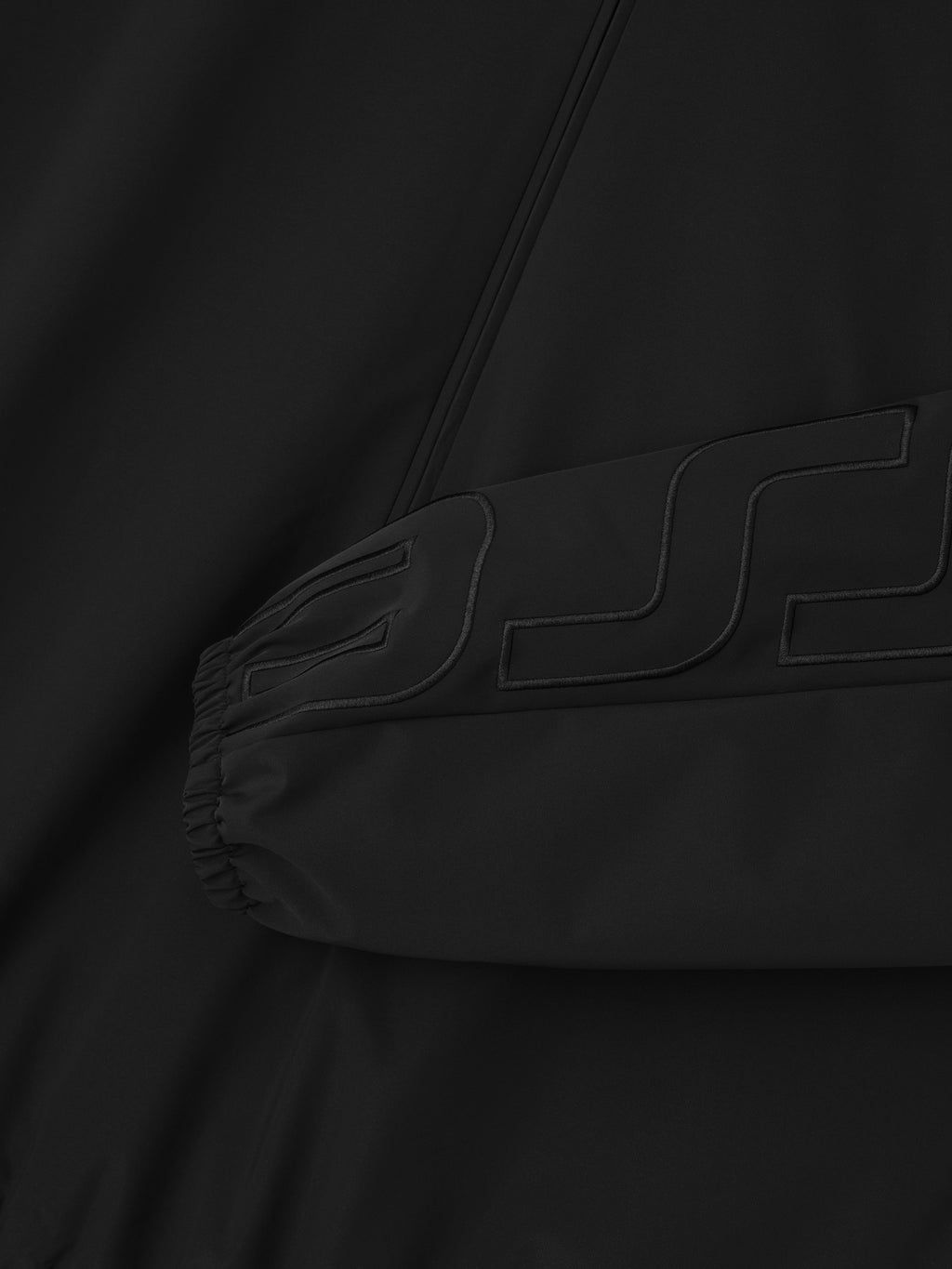 Sleeve logo printing detail- black raided letters on black.