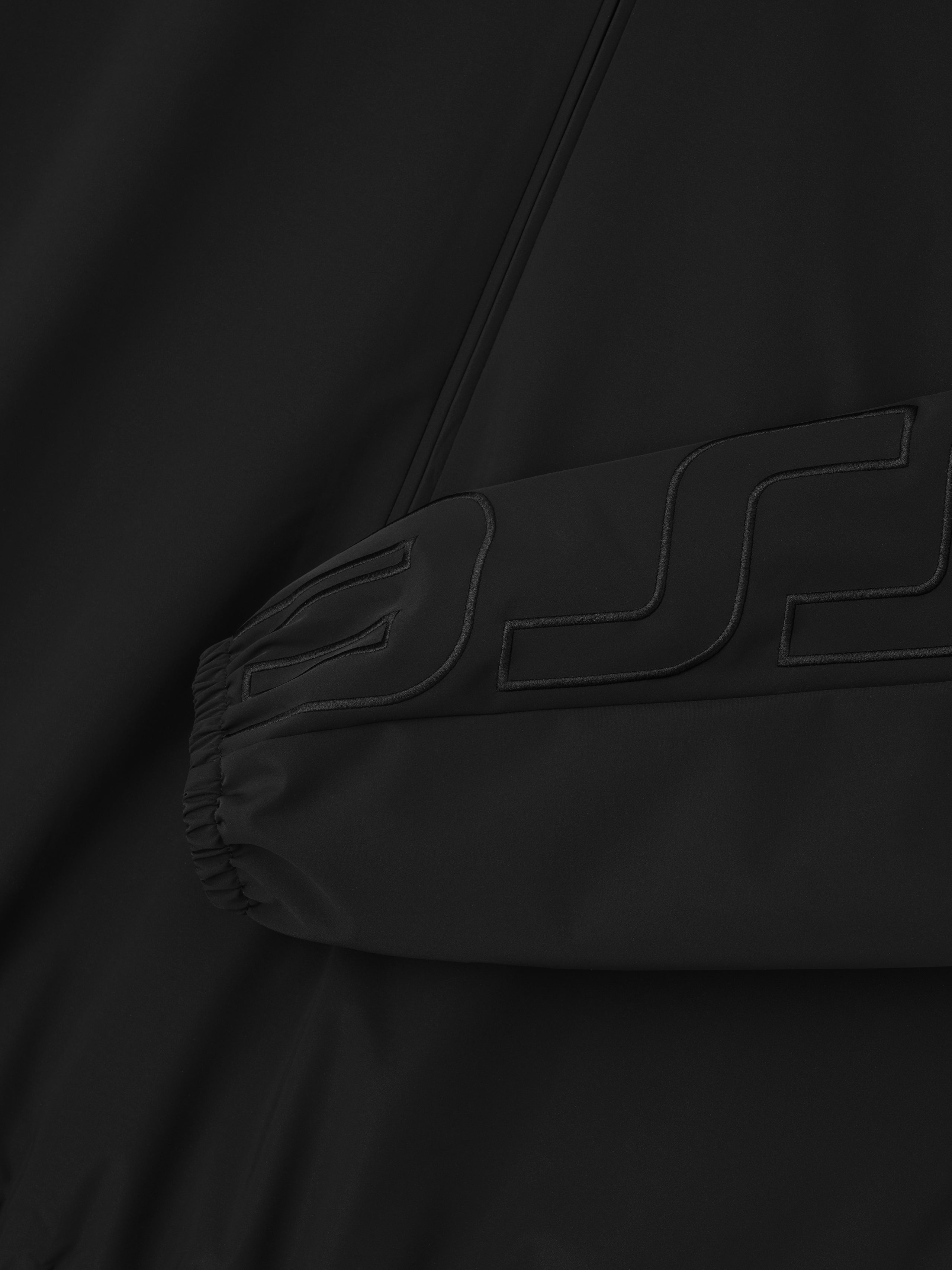 Sleeve logo printing detail- black raided letters on black.