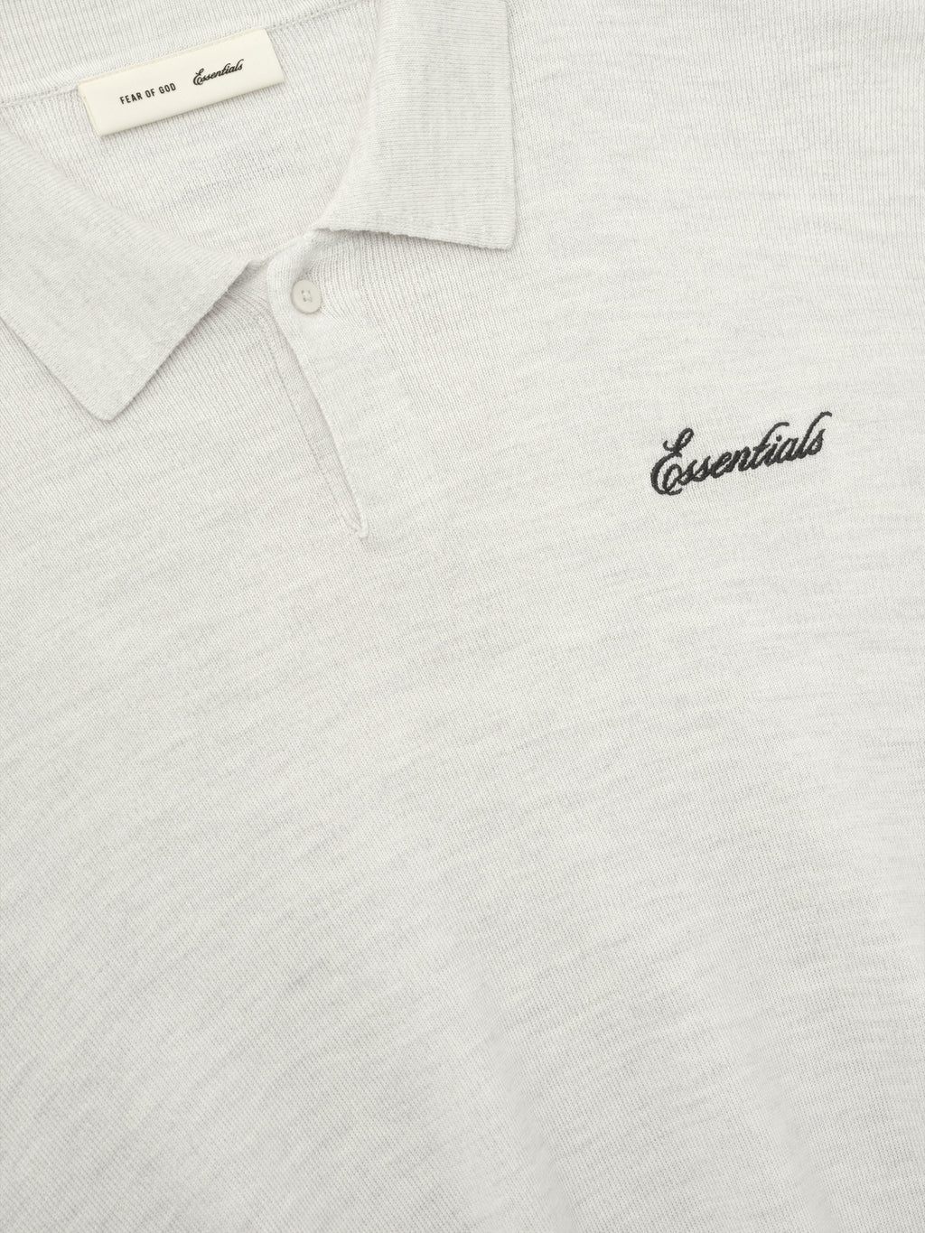 off-white heavy merino knit polo with classic collar and black Essentials script embroidery on chest