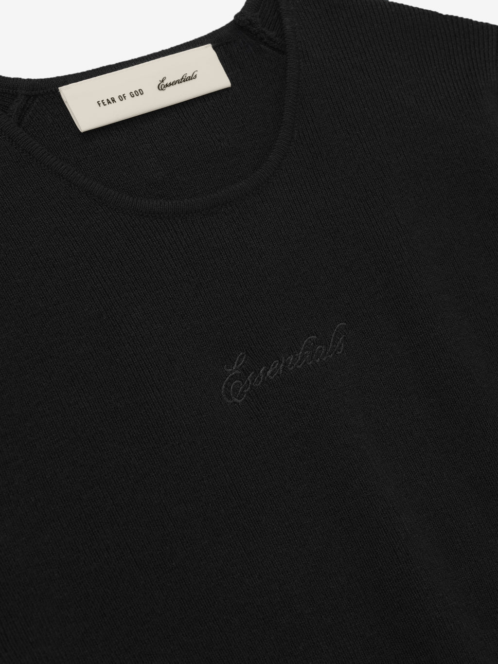 Black sweater with 'Essentials' branding on a white background