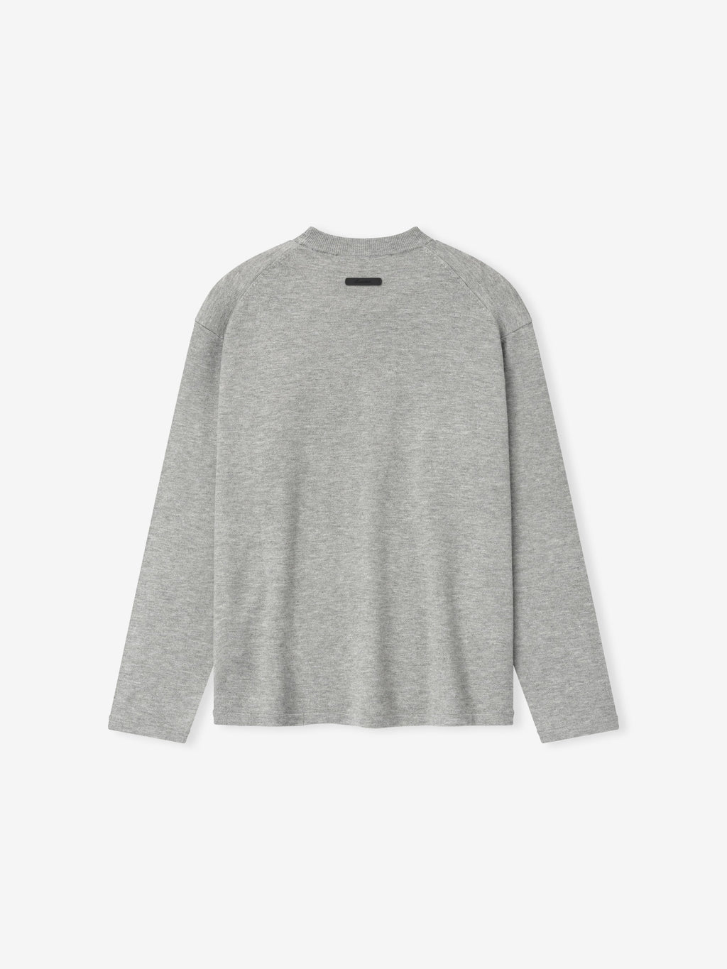 back view of light grey fitted knit long sleeve tee with relaxed silhouette and subtle Essentials label at neckline