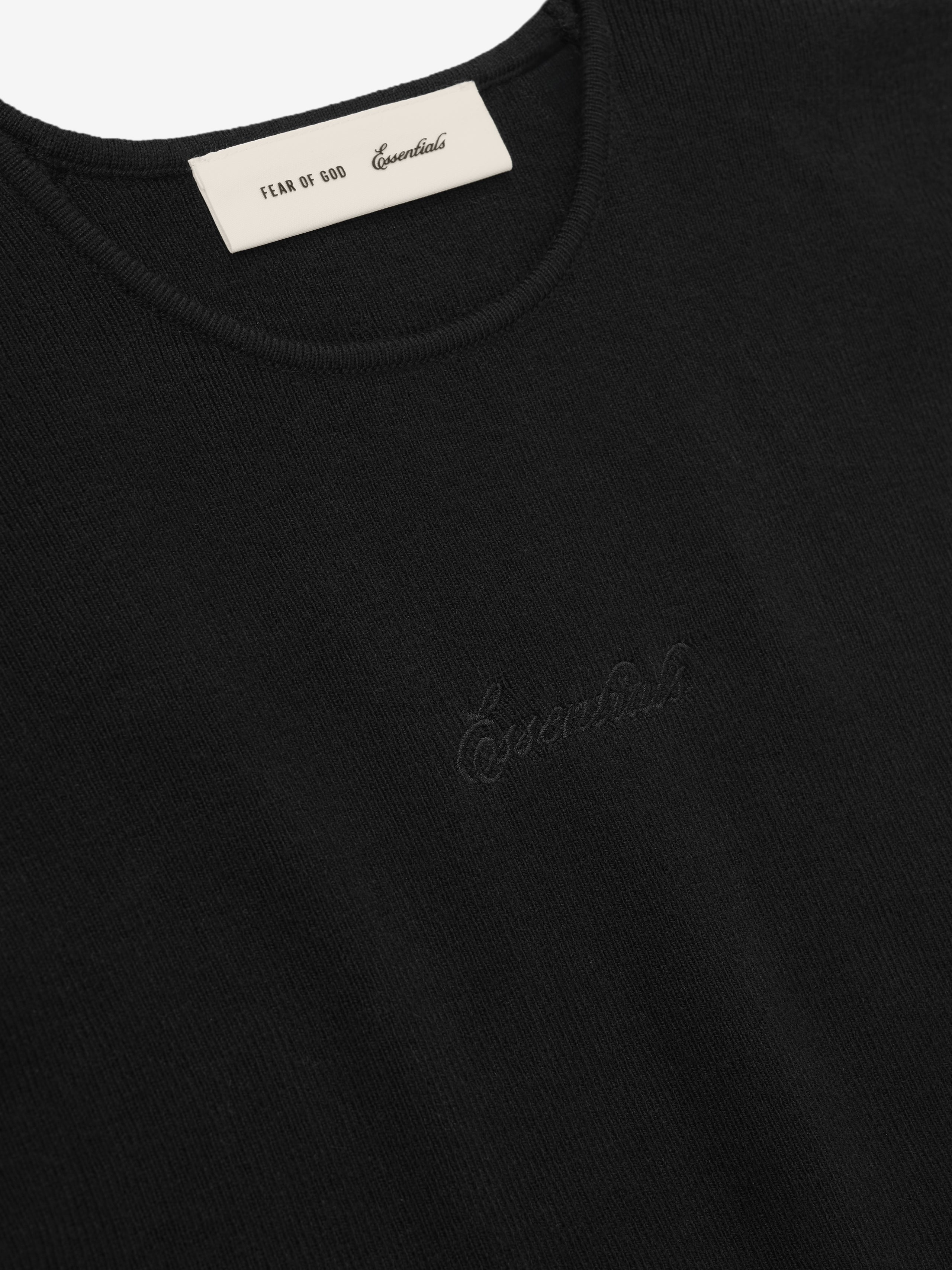Black t-shirt with 'Essential' logo and label on collar