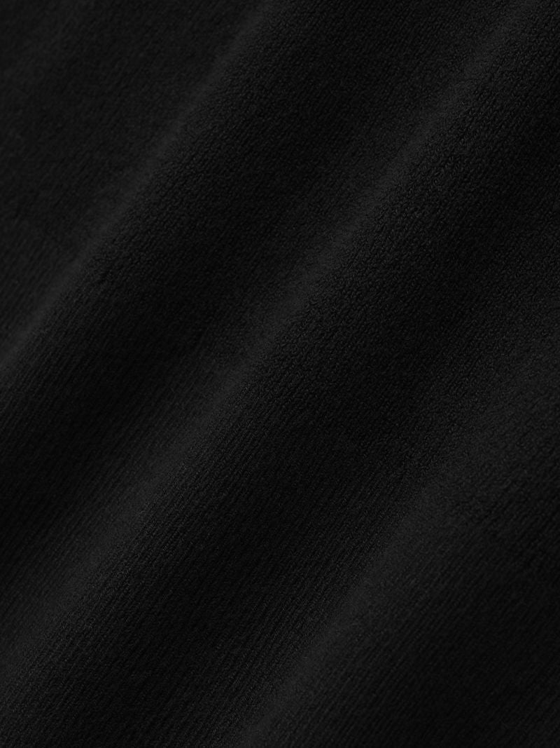 Close-up of smooth black ribbed fabric texture used for women's long sleeve hooded top