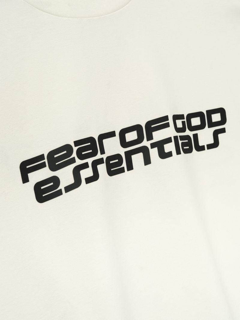 Close-up of off-white Ponte 90s Long Sleeve Tee showing bold black Fear of God Essentials diagonal logo, gallery 0 5U-dUUnA.jpg