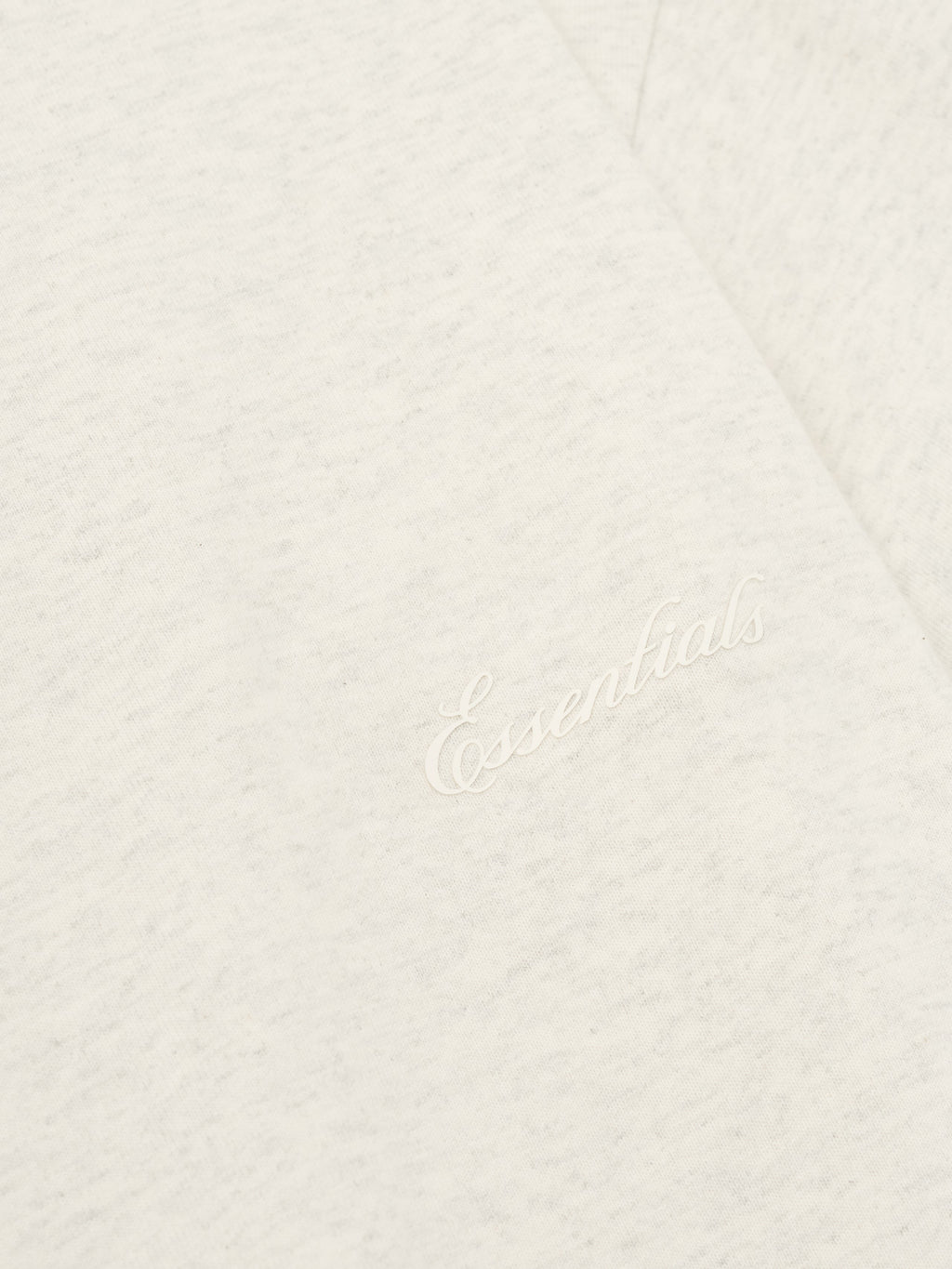Close-up of oatmeal heather Kids Classic Short Sleeve Tee with discreet white embroidered Essentials logo on chest, gallery 0