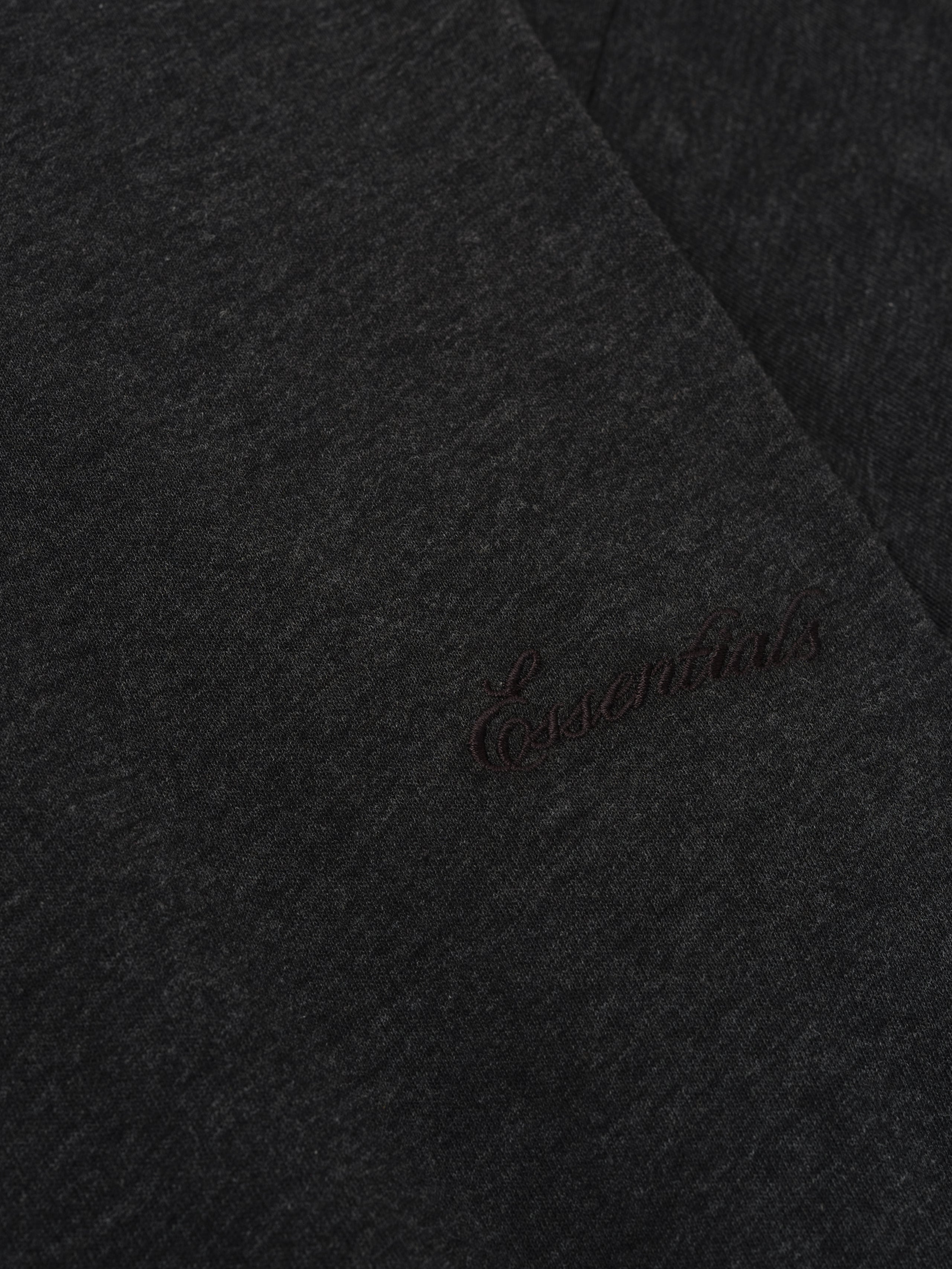 Close-up of vintage black Kids Embroidered Essential Tee showing tonal Essentials script embroidery on fabric, gallery position 0