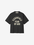 front view of black heavyweight cotton tee with cream Essentials Fear of God logo in oversized 90s fit