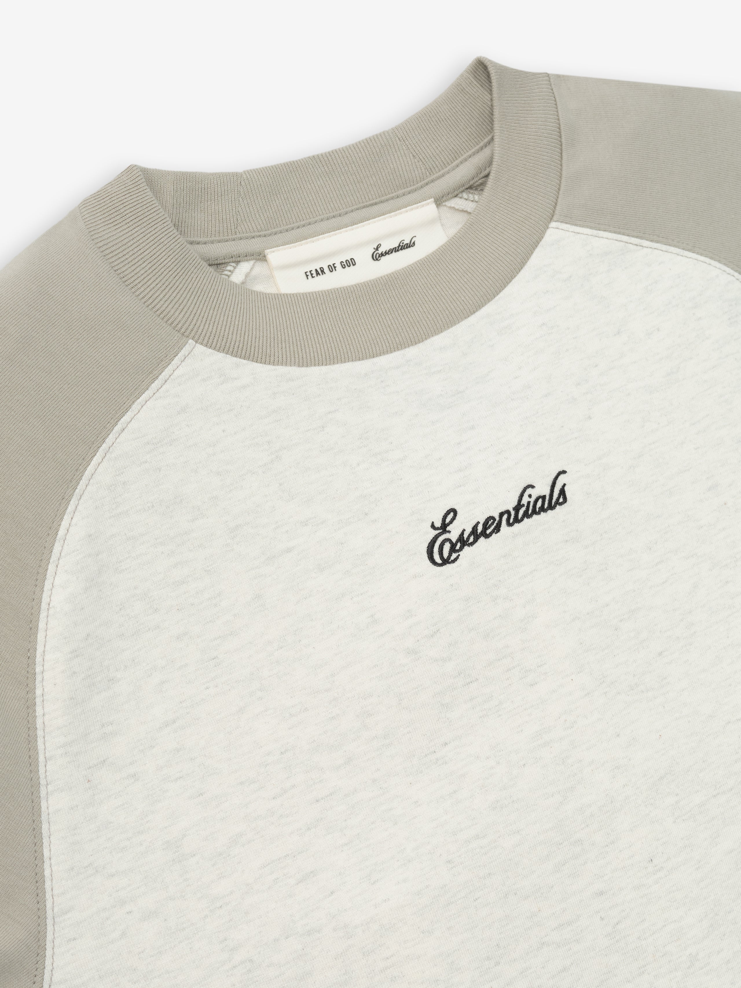 Baseball t-shirt with gray sleeves and white body on a light beige background