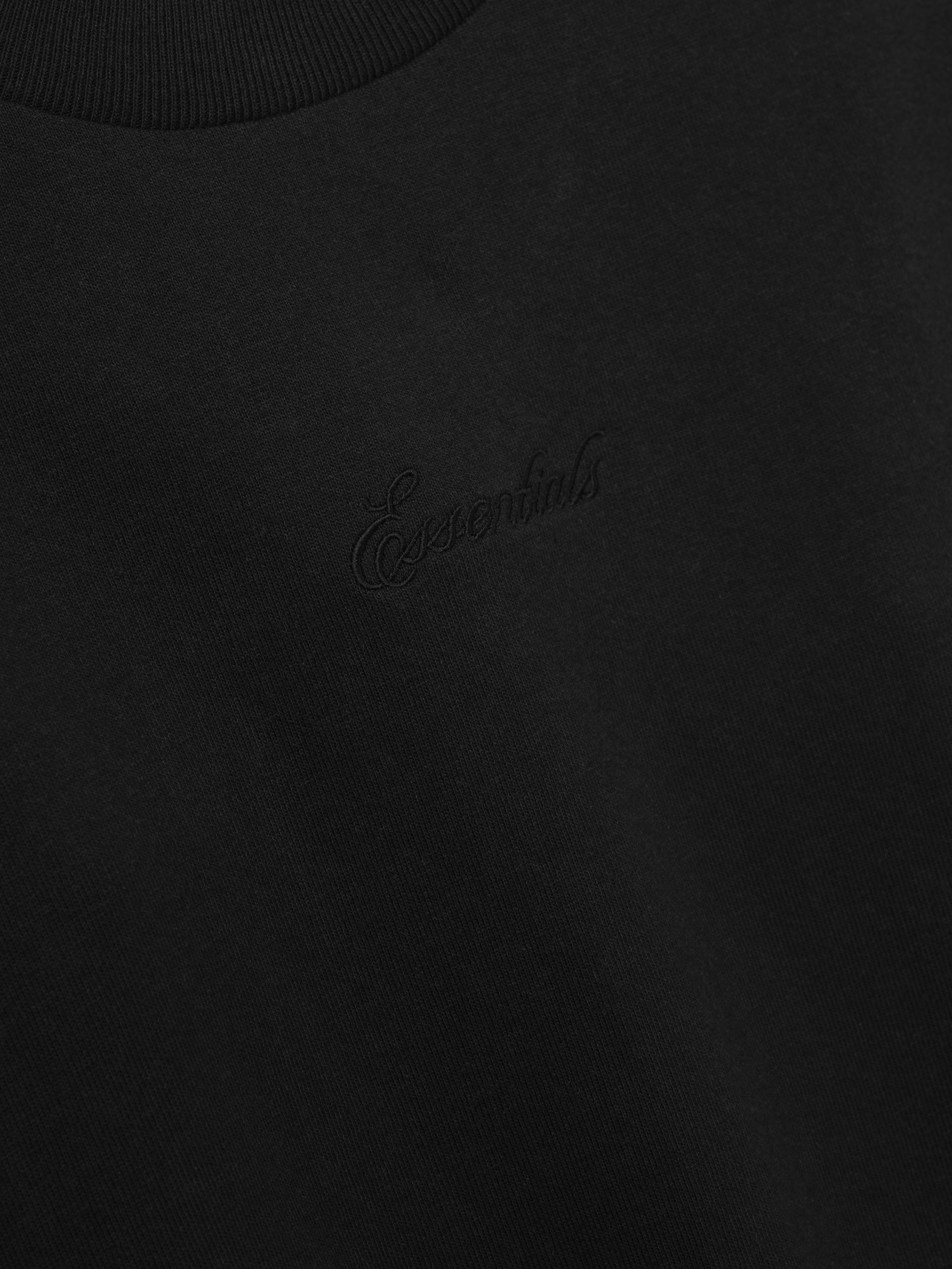 Black t-shirt with a essentials embroidered logo on the chest.