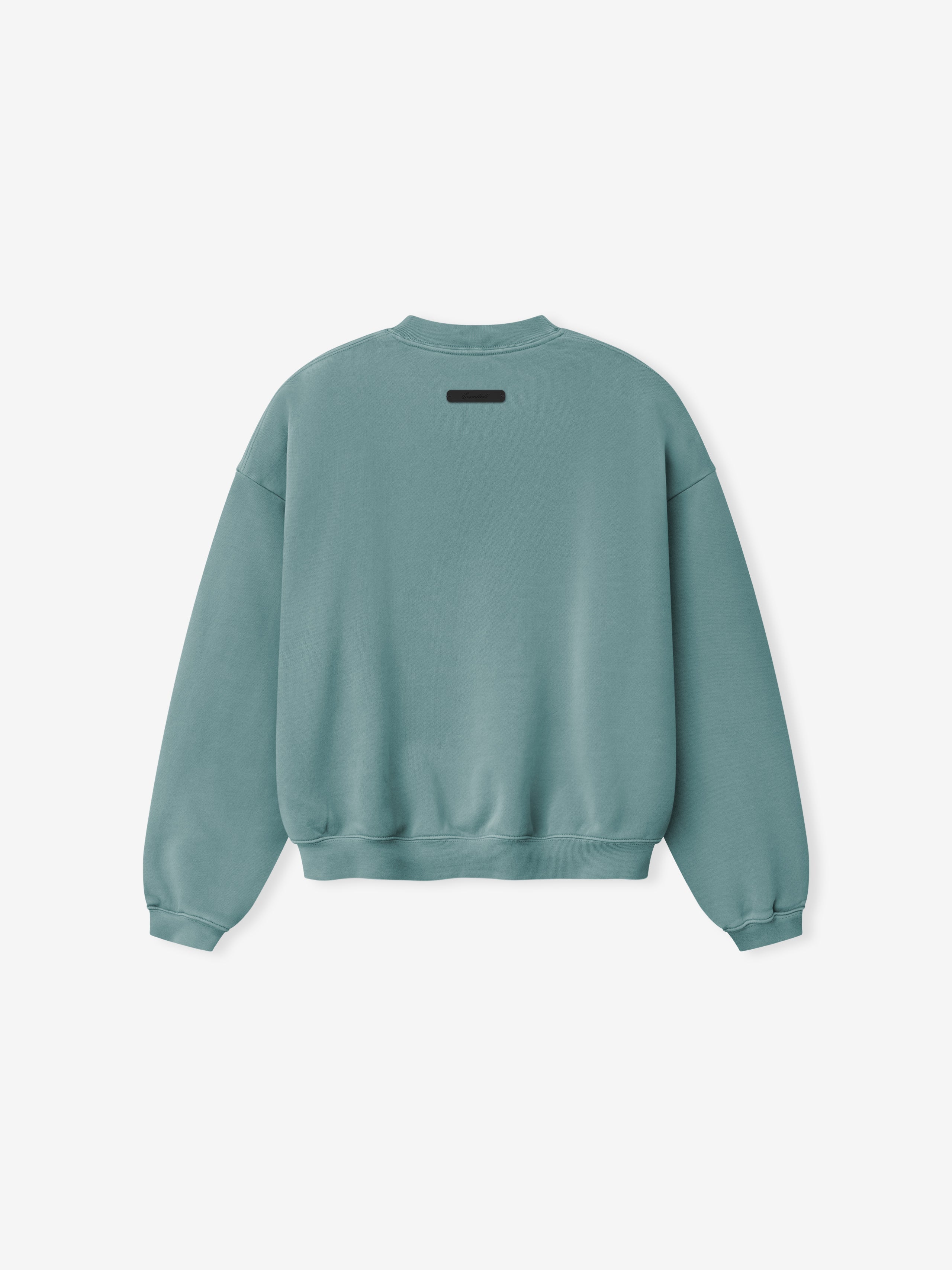 Back view of muted teal crewneck sweatshirt with ribbed cuffs and hem and small black rectangular label near collar