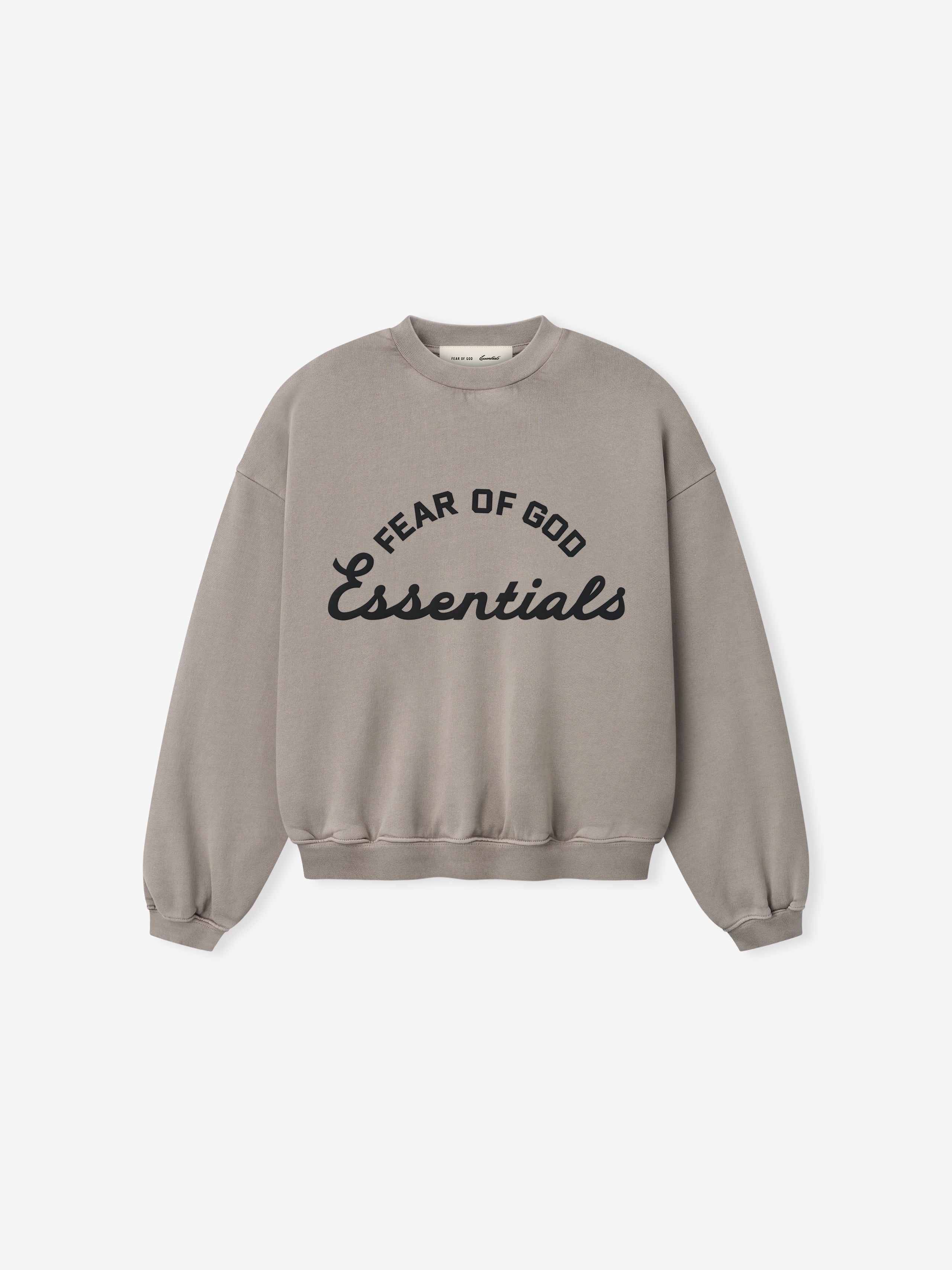 Light brown crewneck sweatshirt with black "Fear of God Essentials" text in curved and script fonts on front center
