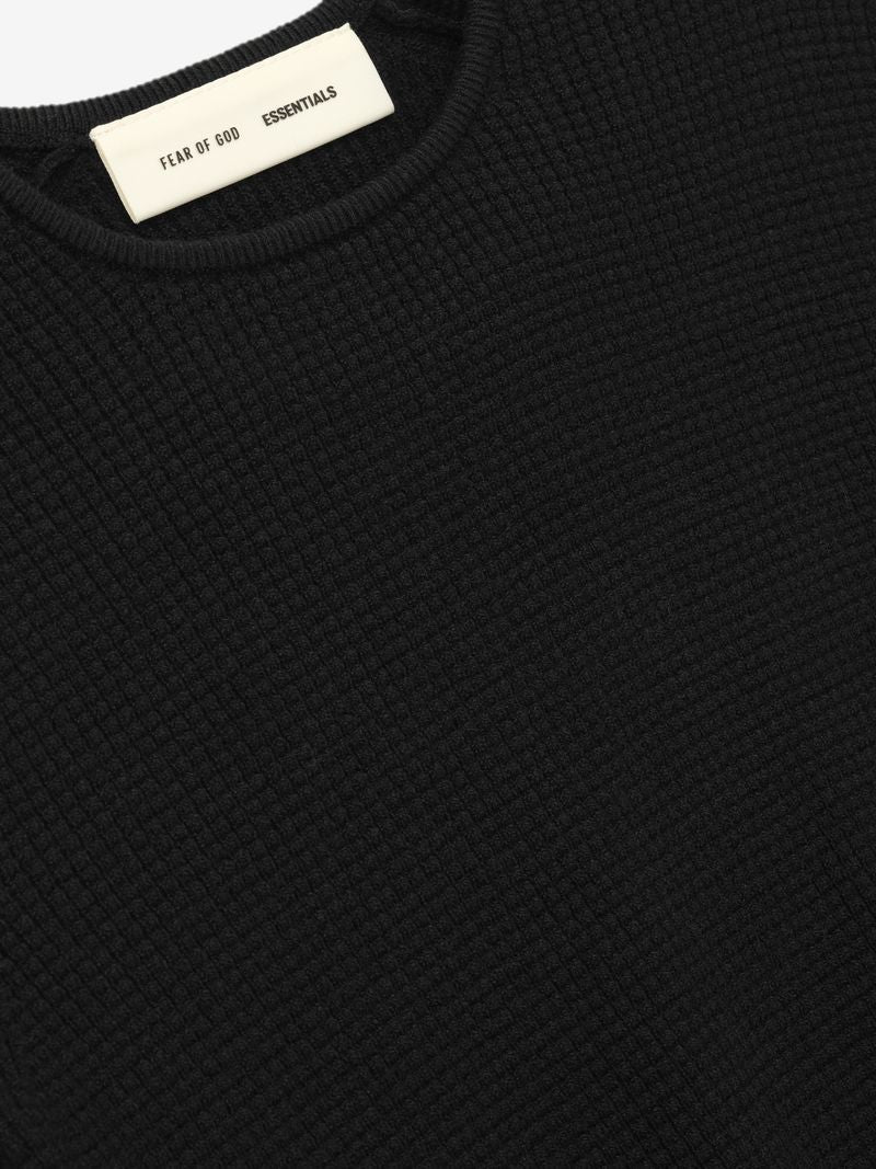 Close-up of black waffle knit long sleeve top with Fear of God Essentials label BEmtHSMQ.jpg gallery 0