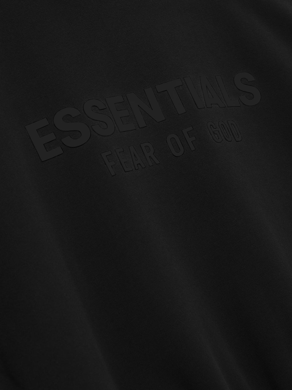 Essentials Classic Crewneck Sweatshirt -Chest Graphic in black fabric with embossed tonal Fear of God branding on the chest, showcasing a sleek and understated design.