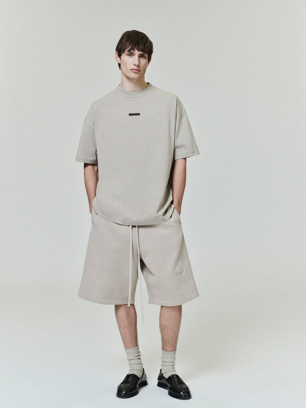 front view of light beige classic fit cotton jersey tee with rib-knit crewneck and small rectangular chest logo