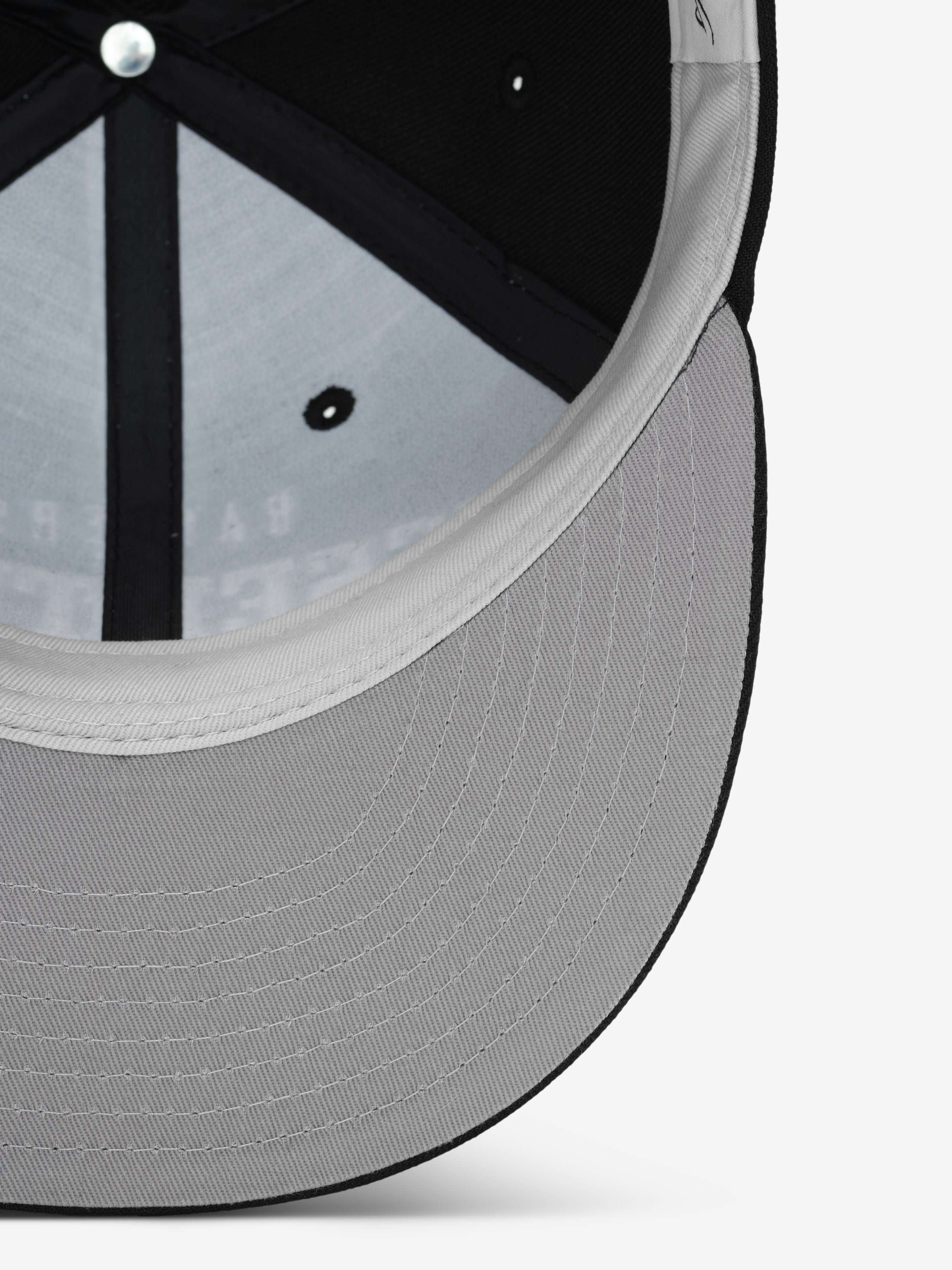 Close-up inside view of Raiders 9Fifty RC Snapback showing light grey underbill and black inner panel, gallery image 0