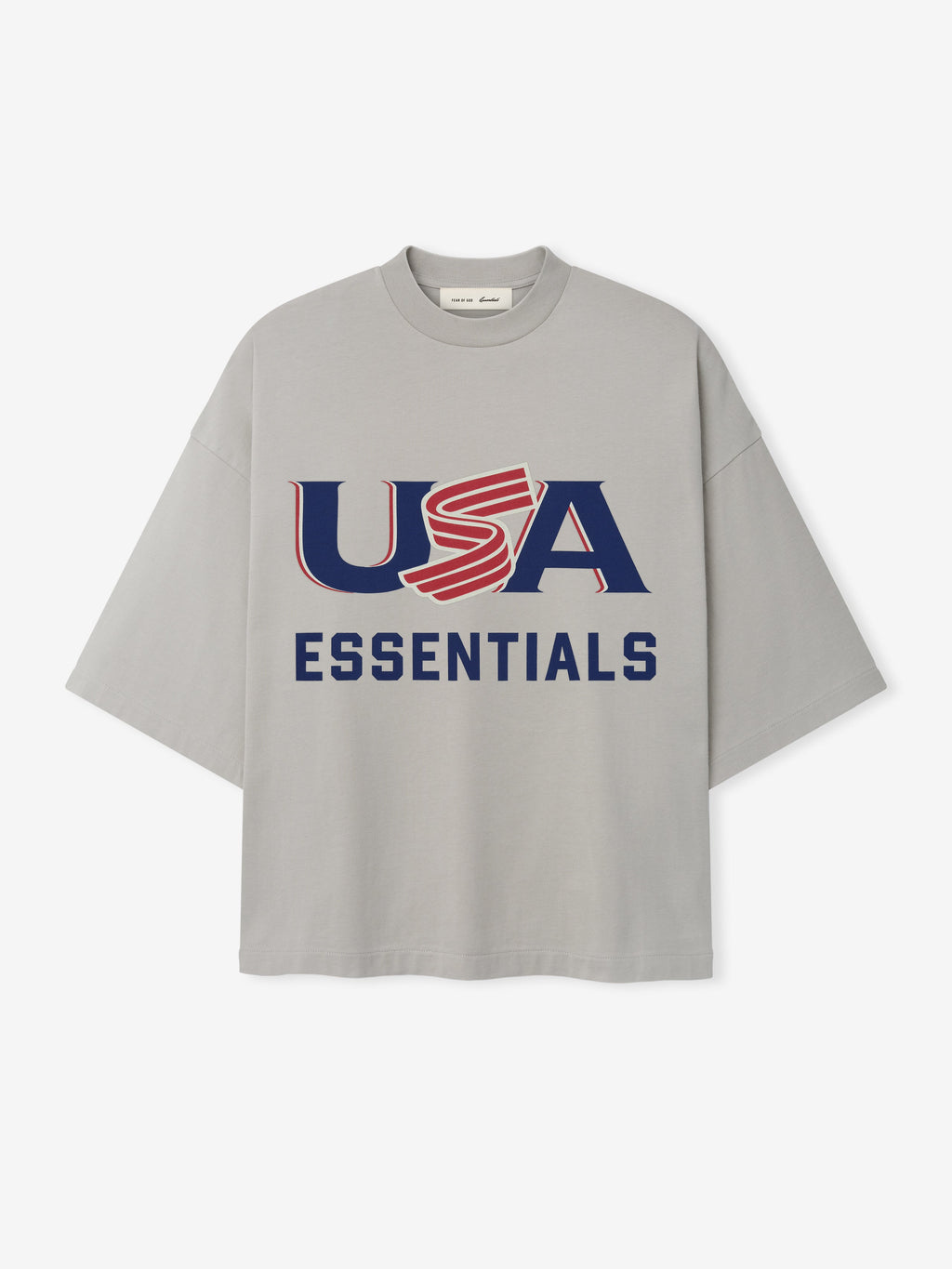 Light gray oversized short-sleeve T-shirt with navy and red "USA ESSENTIALS" graphic on front center