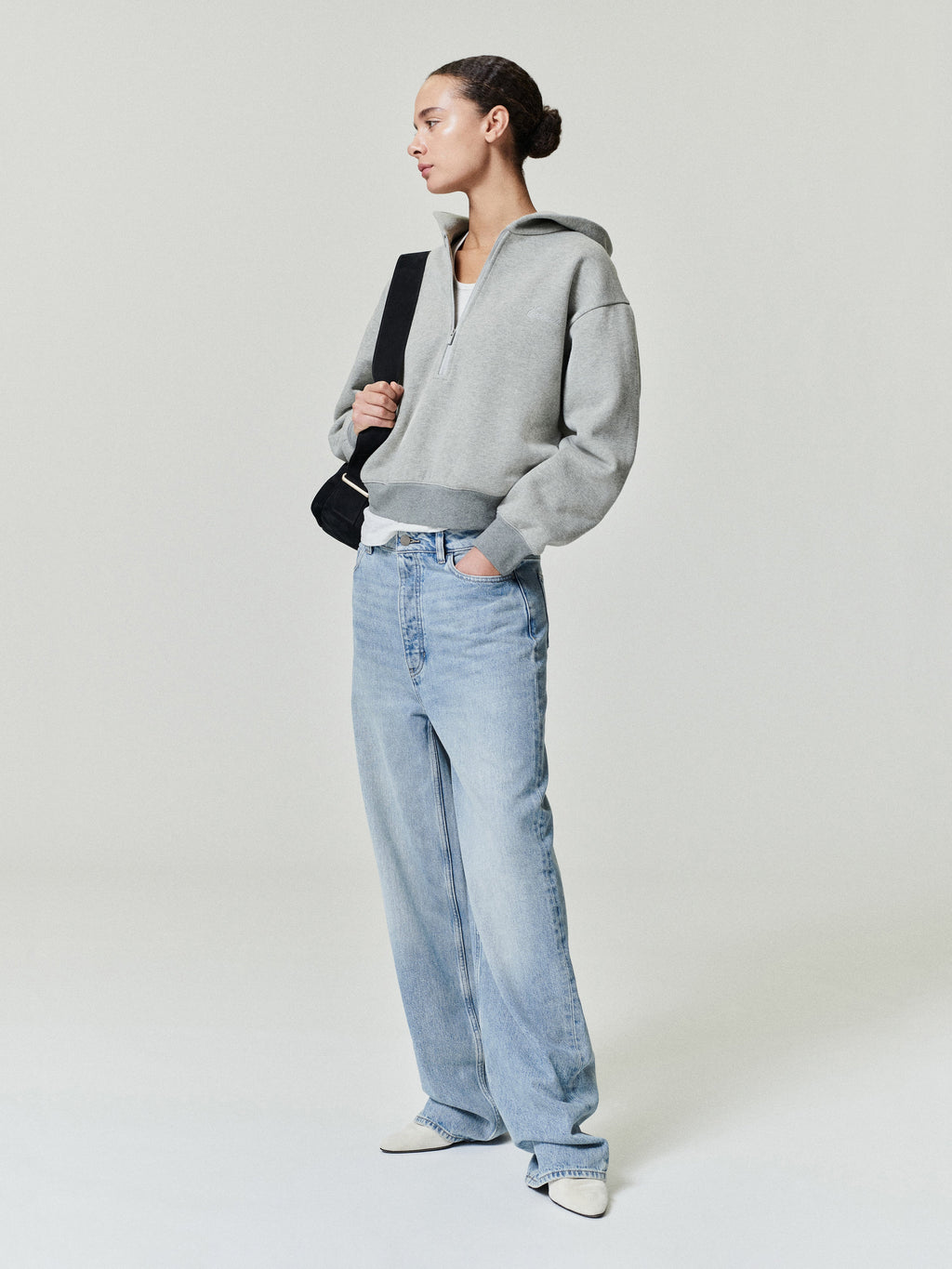 woman wearing vintage wash light blue straight leg denim jeans with relaxed boyfriend-inspired fit and low rise
