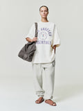 model wearing off-white heavyweight fleece sweatpant with elastic cuffs and NBA x Barkley Hendricks circular logo on thigh