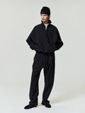 Person wearing a black outfit on a white background