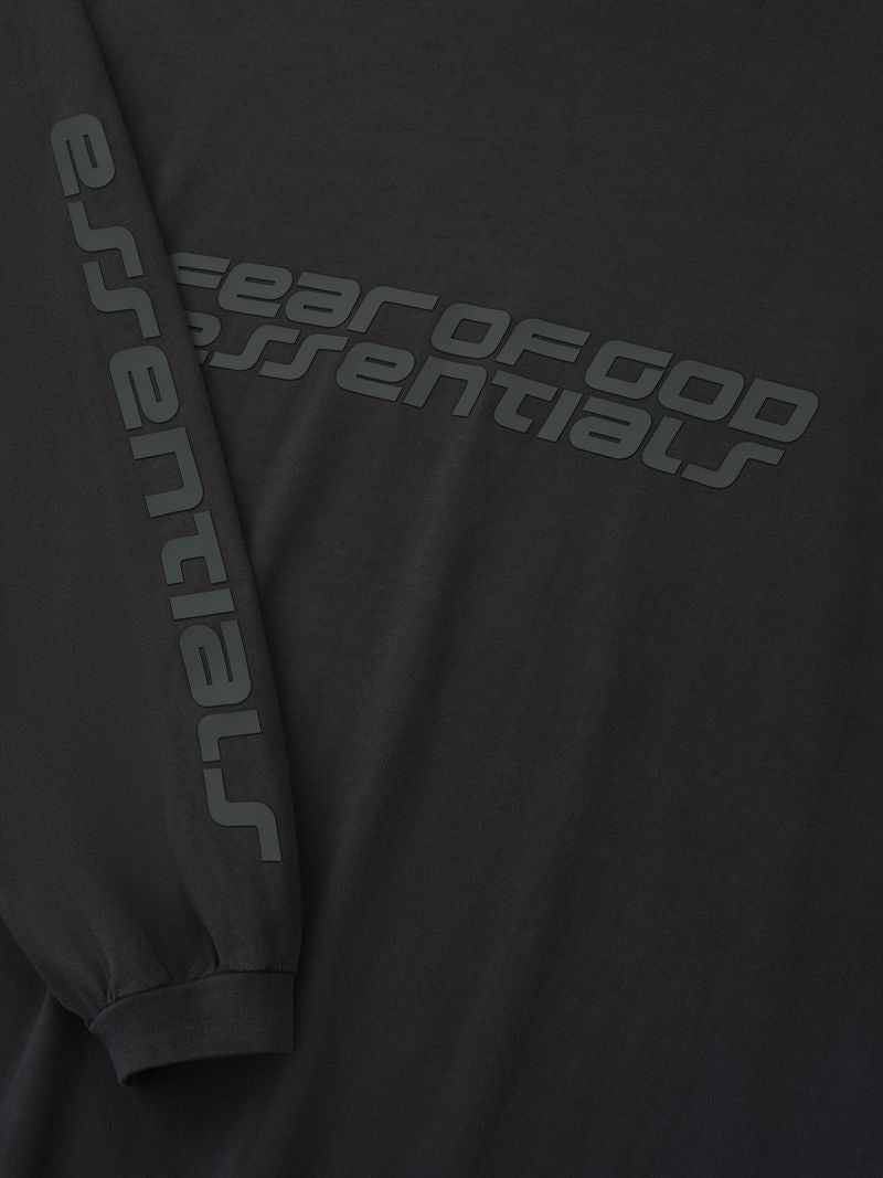 Close-up of black 90s Long Sleeve Tee featuring Fear of God Essentials logo diagonally across chest and sleeve, gallery 0 ZG3IUZRw.jpg