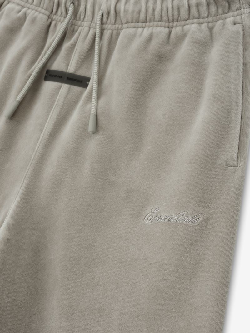 Close-up of light gray kids velour flare sweatpant showing elastic waistband, drawstrings, side pocket, and tonal embroidered branding ffBMSNTg.jpg gallery 0