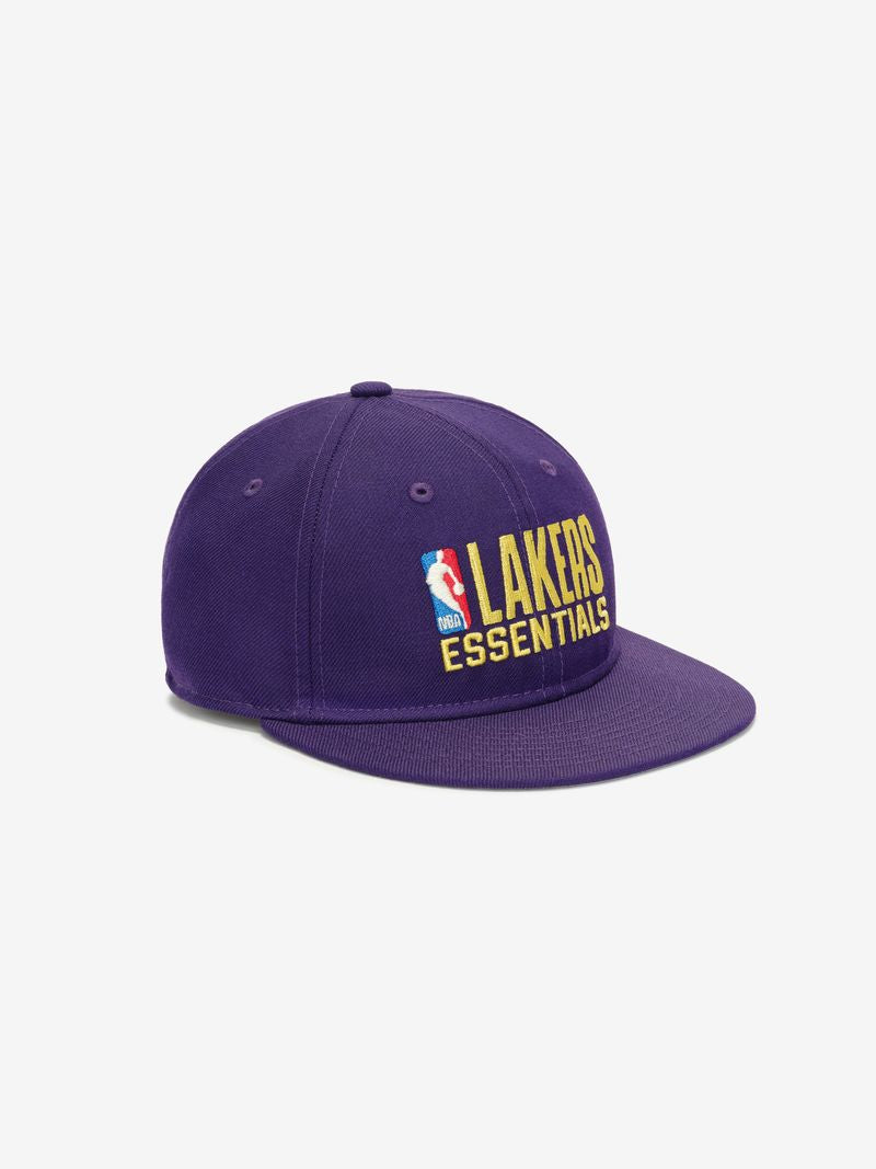 Three-quarter view of purple Lakers 9Fifty snapback with flat brim and embroidered NBA Essentials logo on front panel